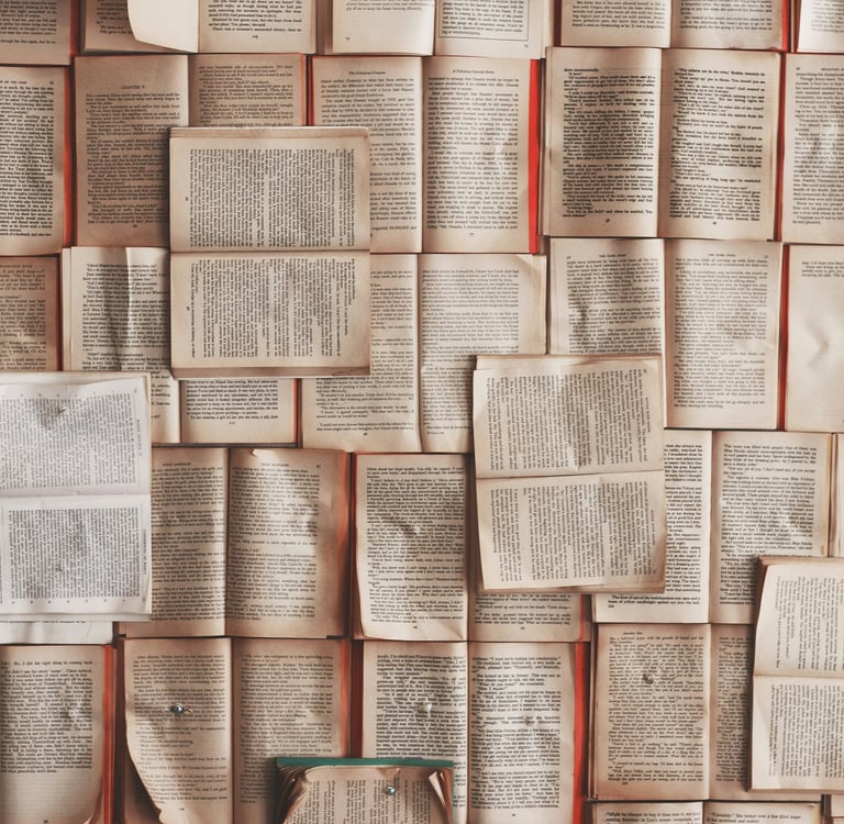a wall of books open on various pages and quotations