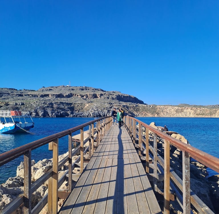 a wooden bridge with a boat in the water