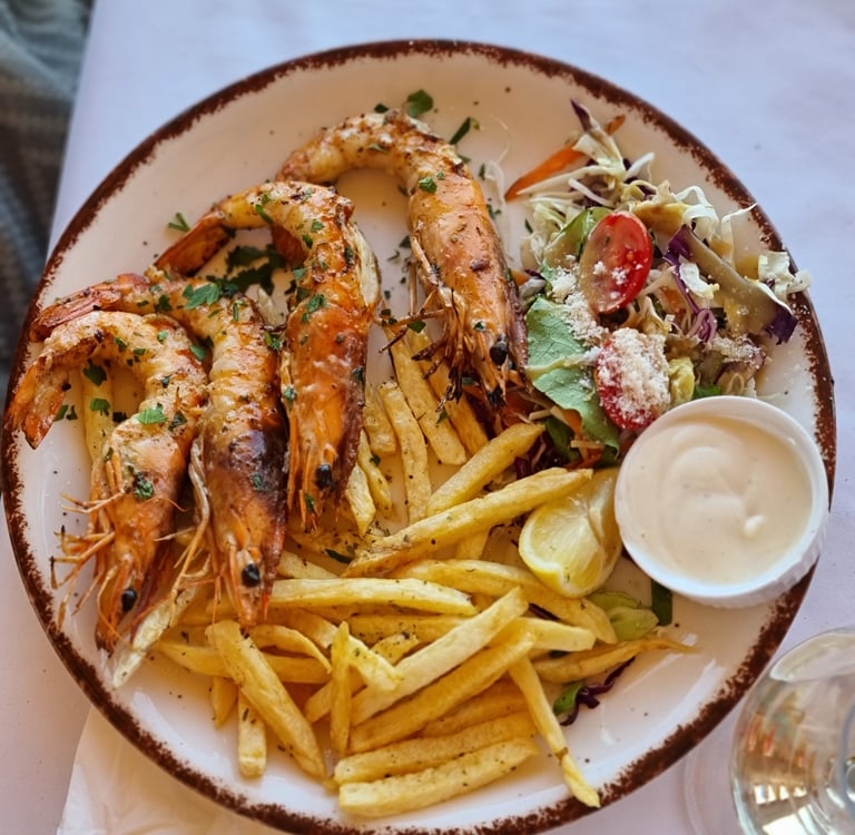 a plate of food with shrimp and fries