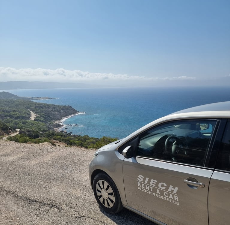 A Siech rent a car parked on a scenic coastal overlook with views of the blue Mediterranean Sea and shoreline.