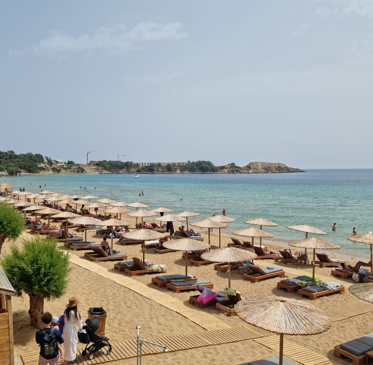 a beach with many lounge chairs and umbrellas