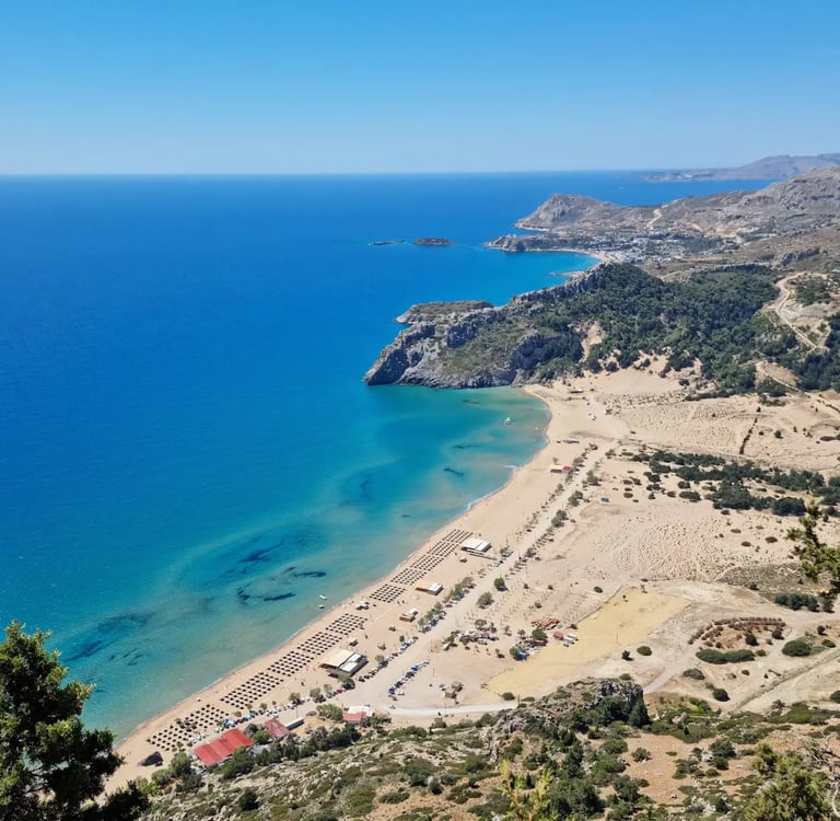 a beach with a sandy beach and a blue sky