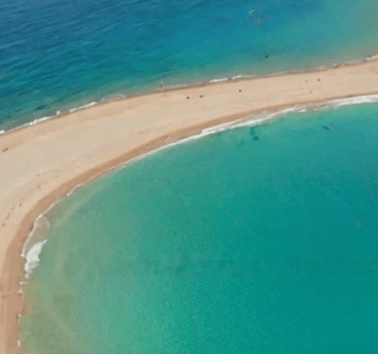 a beach with a sandy beach in prasonisi