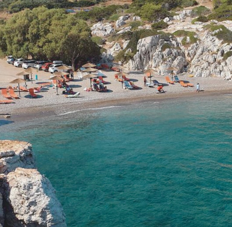 a beach with many chairs and umbrellas