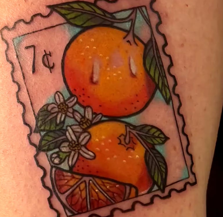 Vintage postage stamp tattoo featuring oranges, citrus blossoms, and a 7 cent mark.