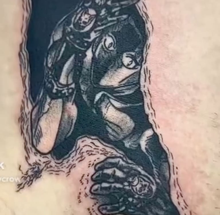 Detailed black and grey anime tattoo of Killer Queen from JoJo's Bizarre Adventure emerging through skin.