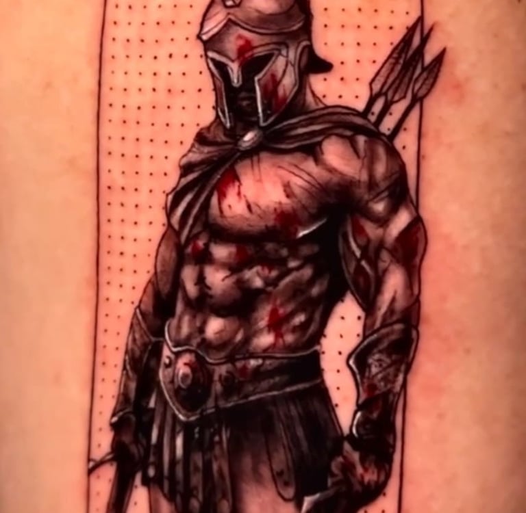 Detailed Spartan warrior tattoo with helmet, spear, and blood splatter on skin.