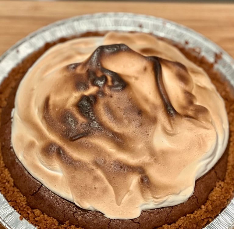 6-inch S'mores Brownie Pie topped with toasted Swiss meringue on a graham cracker crust.