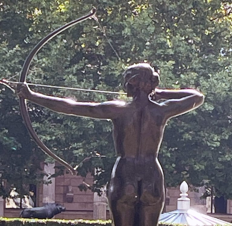 a statue of a woman with a bow and arrow