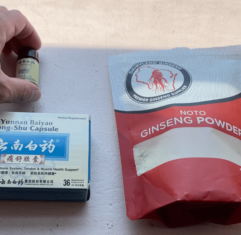 a person holding a bottle of notogingseng powder, with two other brands of same on windowsill
