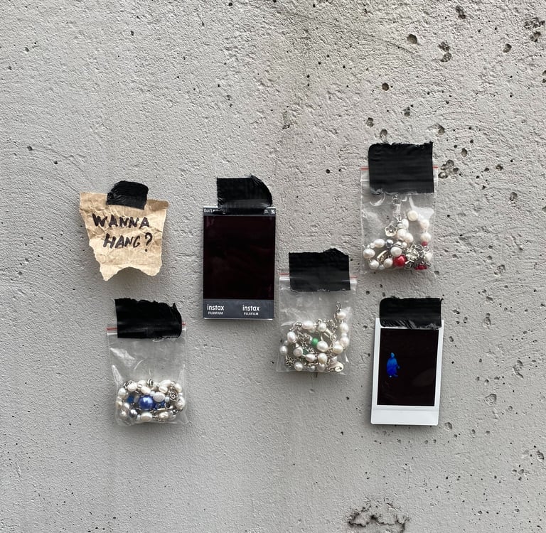 fun.arc.ik. necklaces in zip-lock bags on a concrete wall product picture