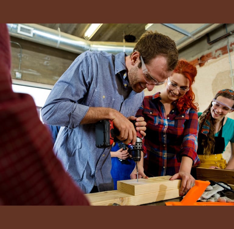 people working with wood in the makerspace