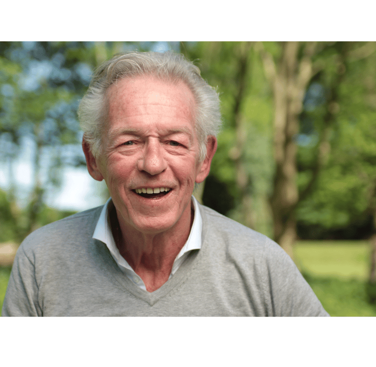 an older man with a smile on his face