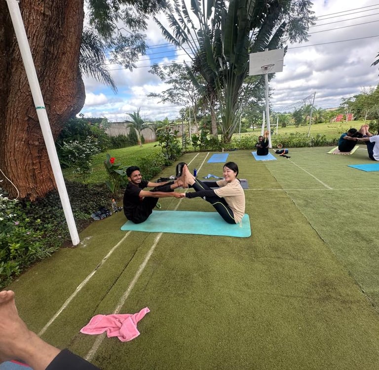 yoga participants trying partner pose for flexibility and endurance