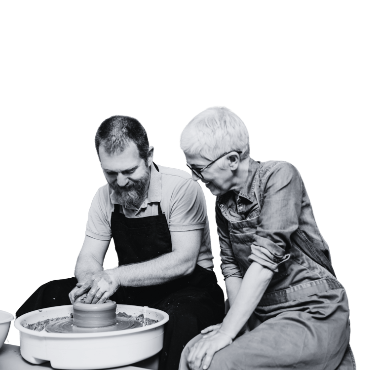 A man and woman using a pottery wheel