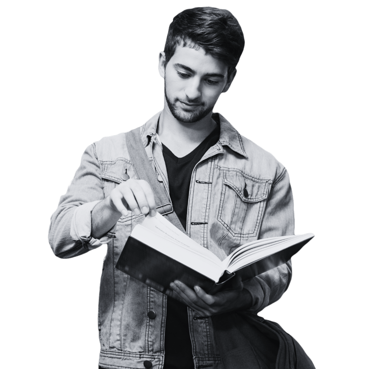 A man reading a book he is holding open