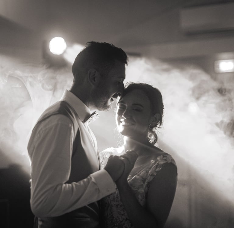 a man and woman standing in front of a smoke filled room