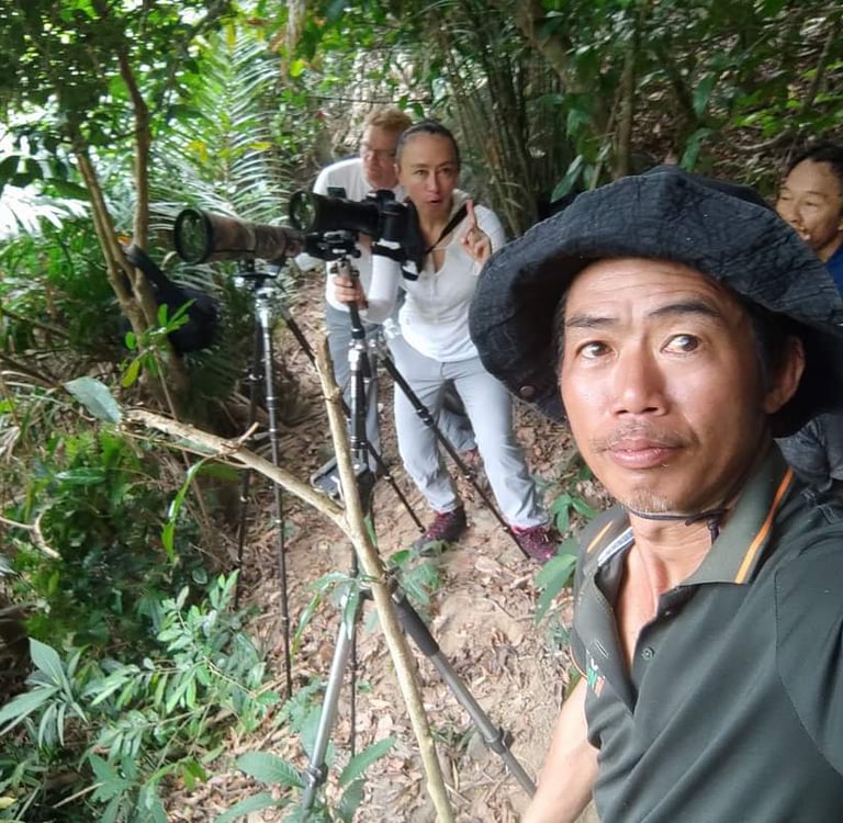 A local Da Nang guide leading professional photographers on a specialized wildlife photography tour.