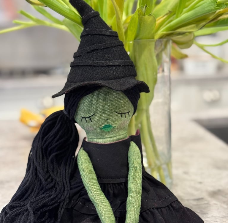a stuffed toy of a green witch