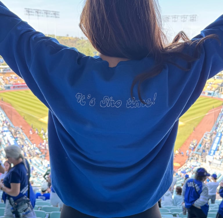 back of a sweatshirt on a girl at a baseball stadium