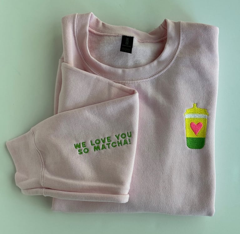 pink sweatshirt with a cup of matcha embroidered on it