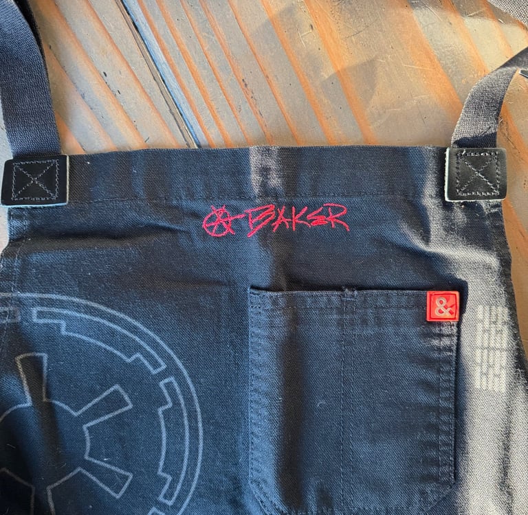 an apron with handwriting embroidered on it