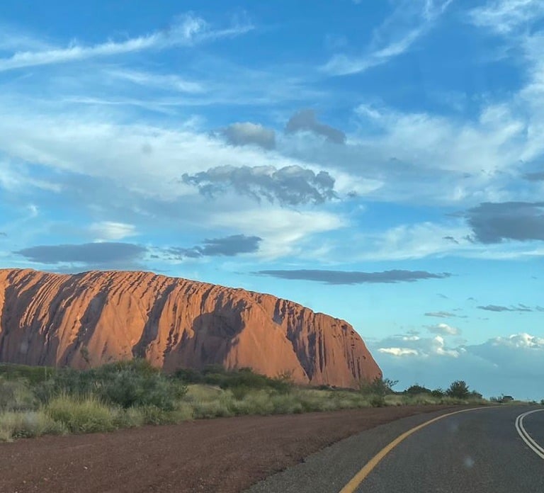 red rock in front of blue sky uluru