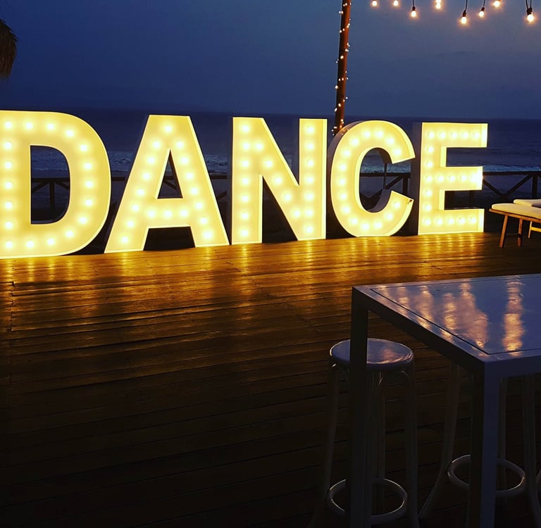 a large light up sign that says dance