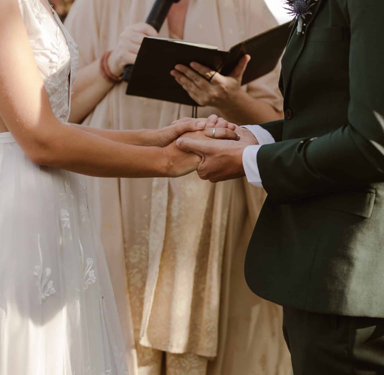 a man and woman holding hands while holding hands