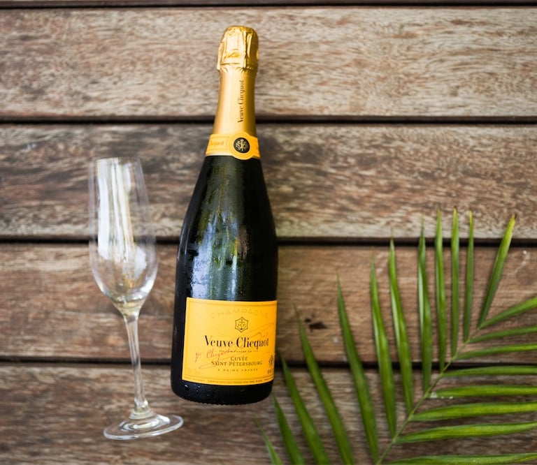a bottle of champagne in front of a wooden table