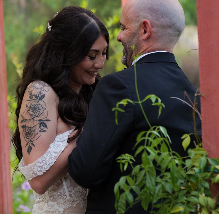 a man and woman standing in front of a gazeboar