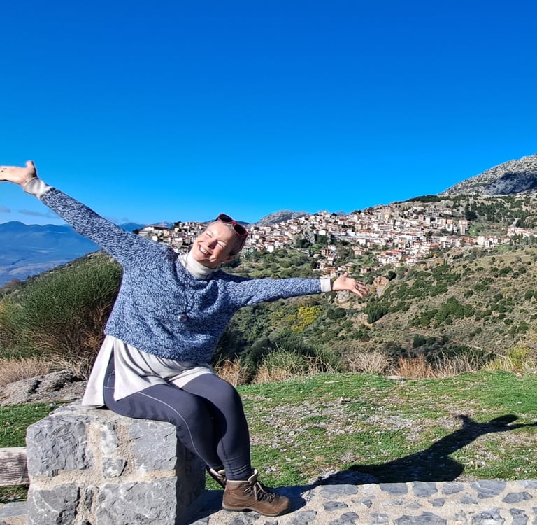 happy woman sitting in mountains