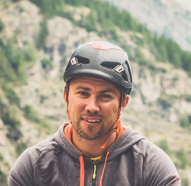 a man in a helmet on a mountain