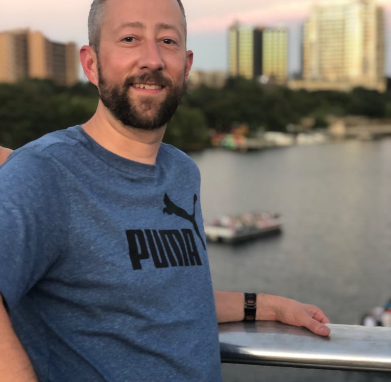 a man with a beard and a blue shirt