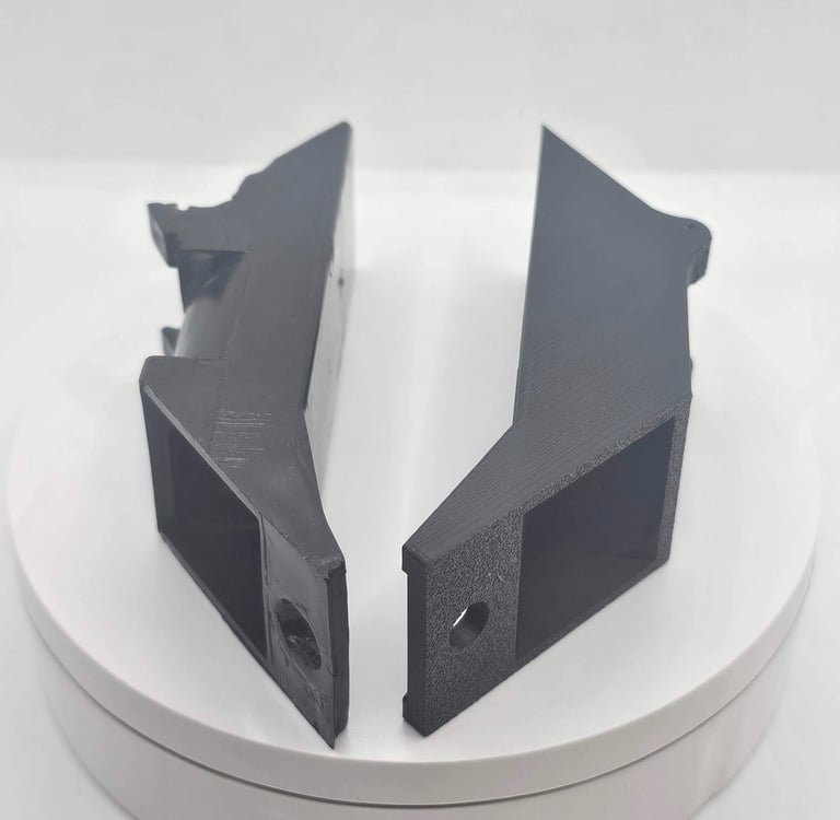 a pair of black and white plastic brackets