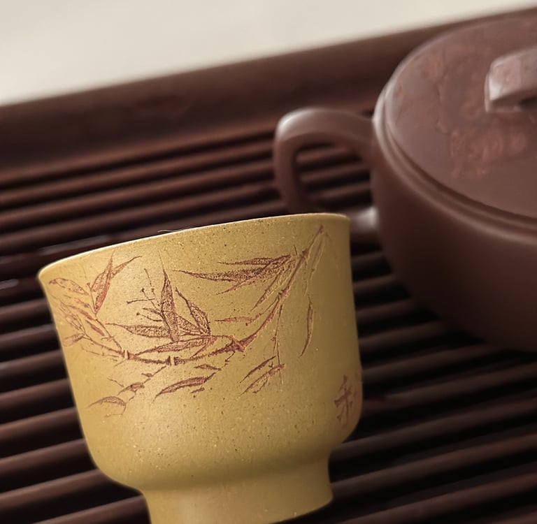 Yellow teacup engraved with artwork