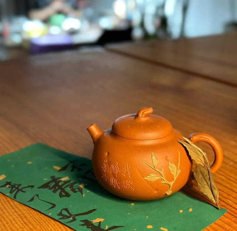 A brown teapot placed on green paper with text written on it