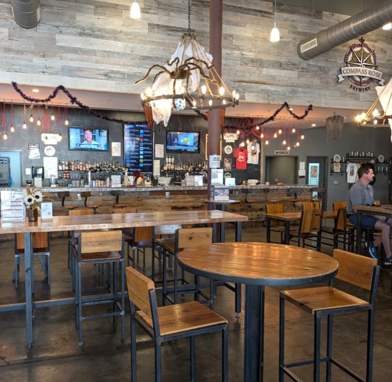 Interior of Compass Rose Brewery tap room with tables and chairs