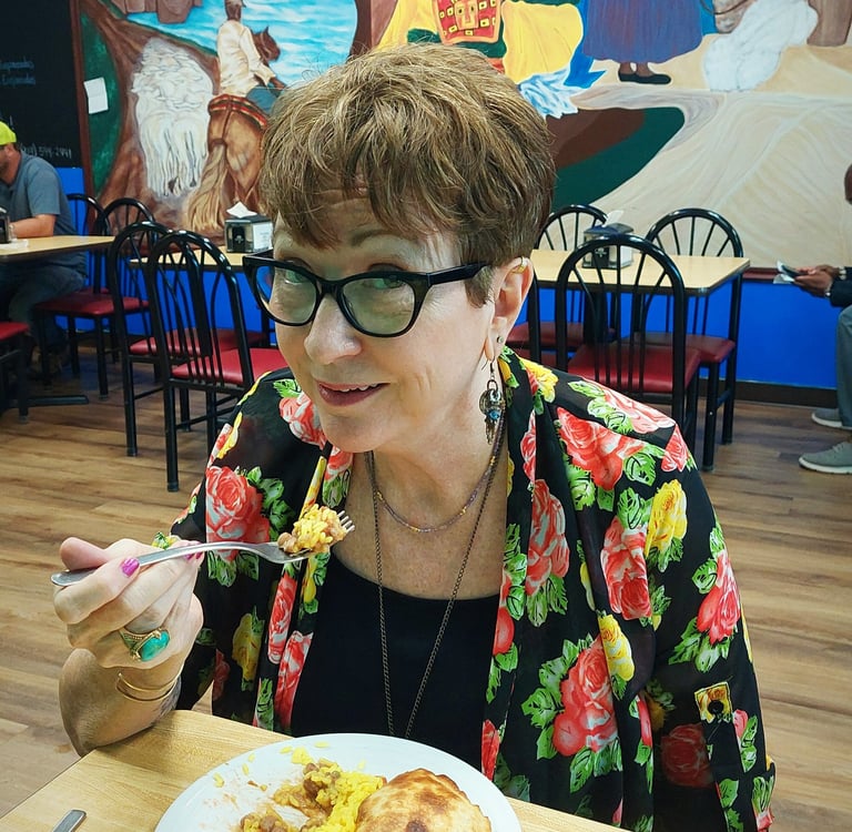 Woman eating a plate of empanadas