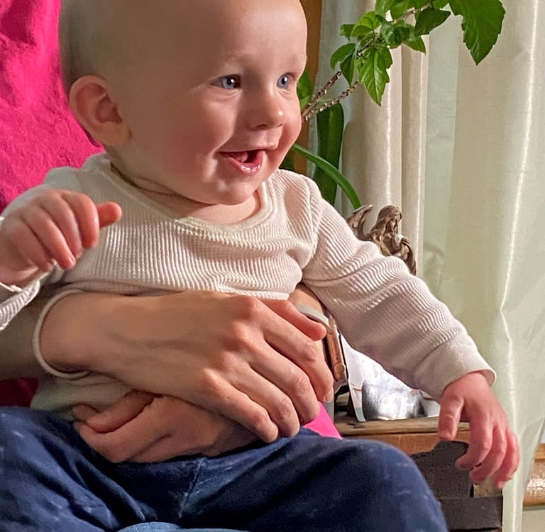 a nine month old smiling baby