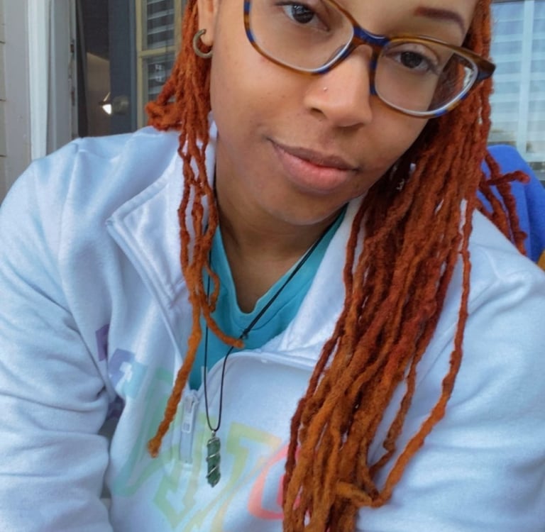 A woman with glasses smiling