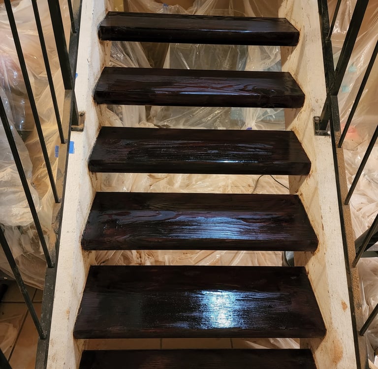 a staircase cased in a plastic bag stained wood stairs