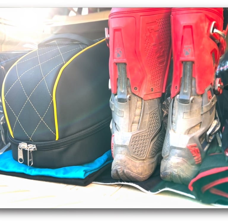 a pair of mx boots and a luxury helmet bag