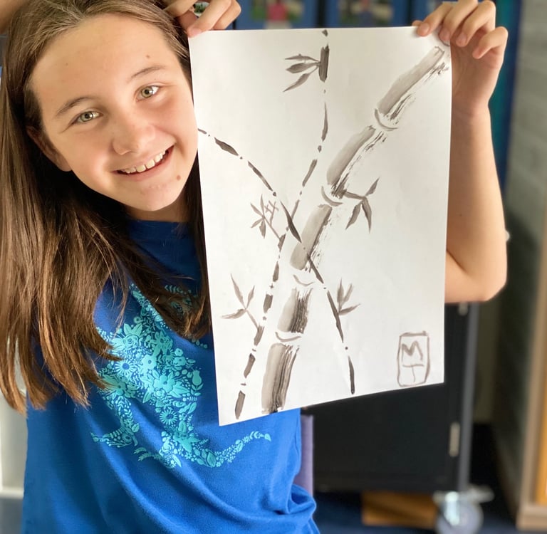 student demonstrating a brush painting