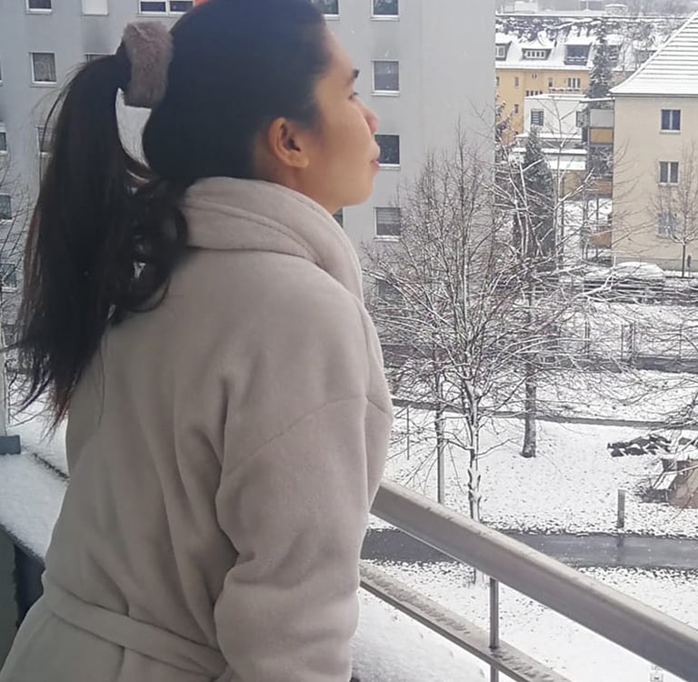 a woman in a coat and a coat over her head