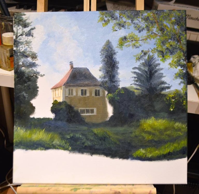an unfinished painting of a house in a studio