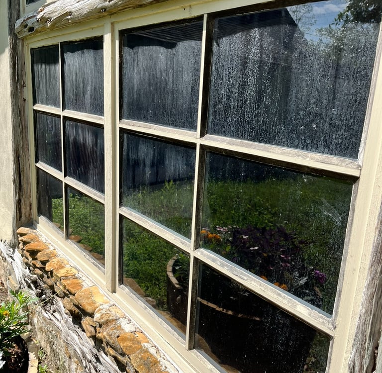 Hard water stains on Hill Country windows cleaned by Elegant Restorations in San Antonio, TX