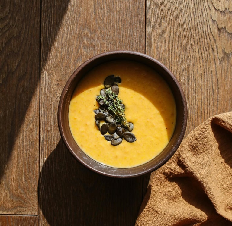 a bowl of soup with pumpkin seeds and pumpkin seeds
