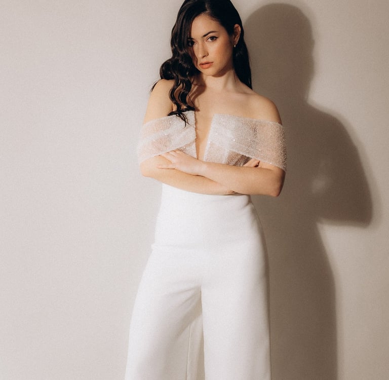 a woman in a white top and pants