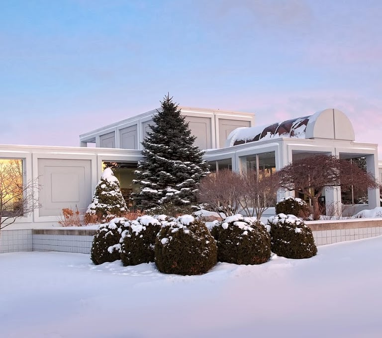 office building with snow covered trees